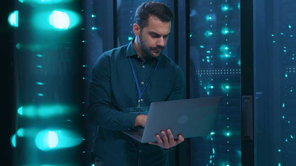 Man in server room on laptop