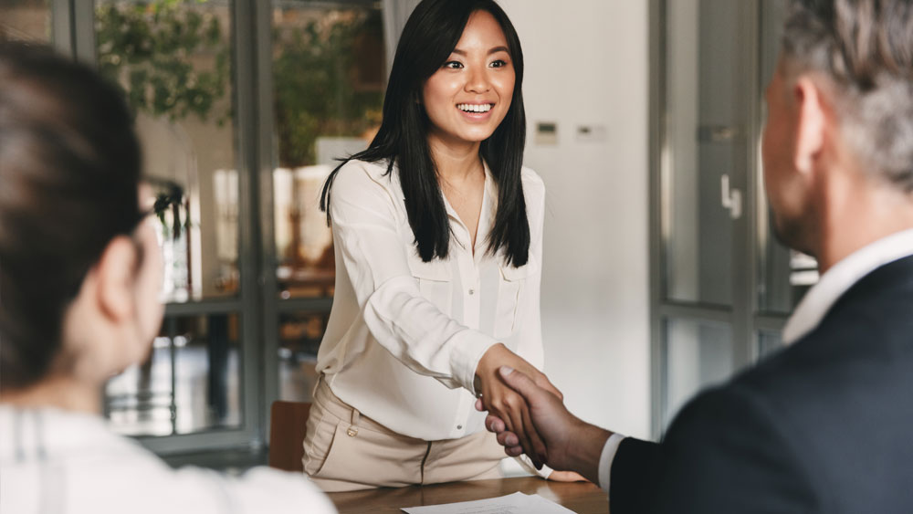 Girl shaking hand in an interview