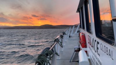 Vessel on water at Sunset