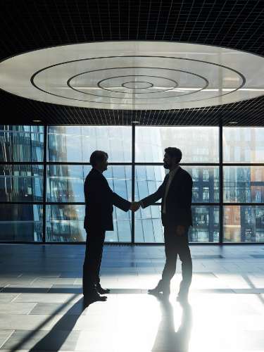 Risk management leaders shaking hands